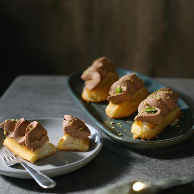 Eclair with pistachio cream and chocolate